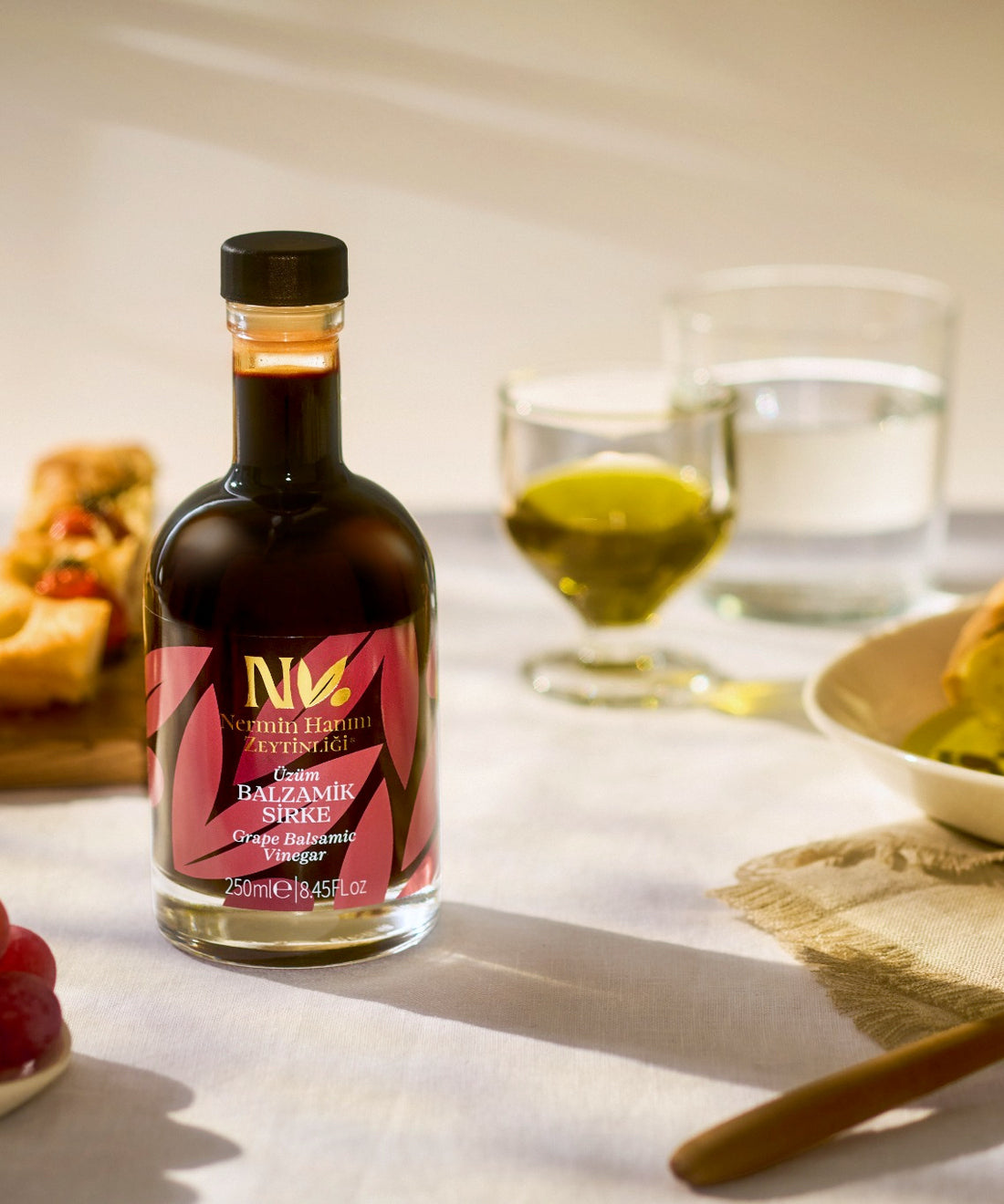 Nermin grape balsamic vinegar bottle set on a dining table