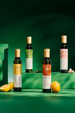 Nermin lemon flavored olive oil tin with other flavored oil bottles and citrus