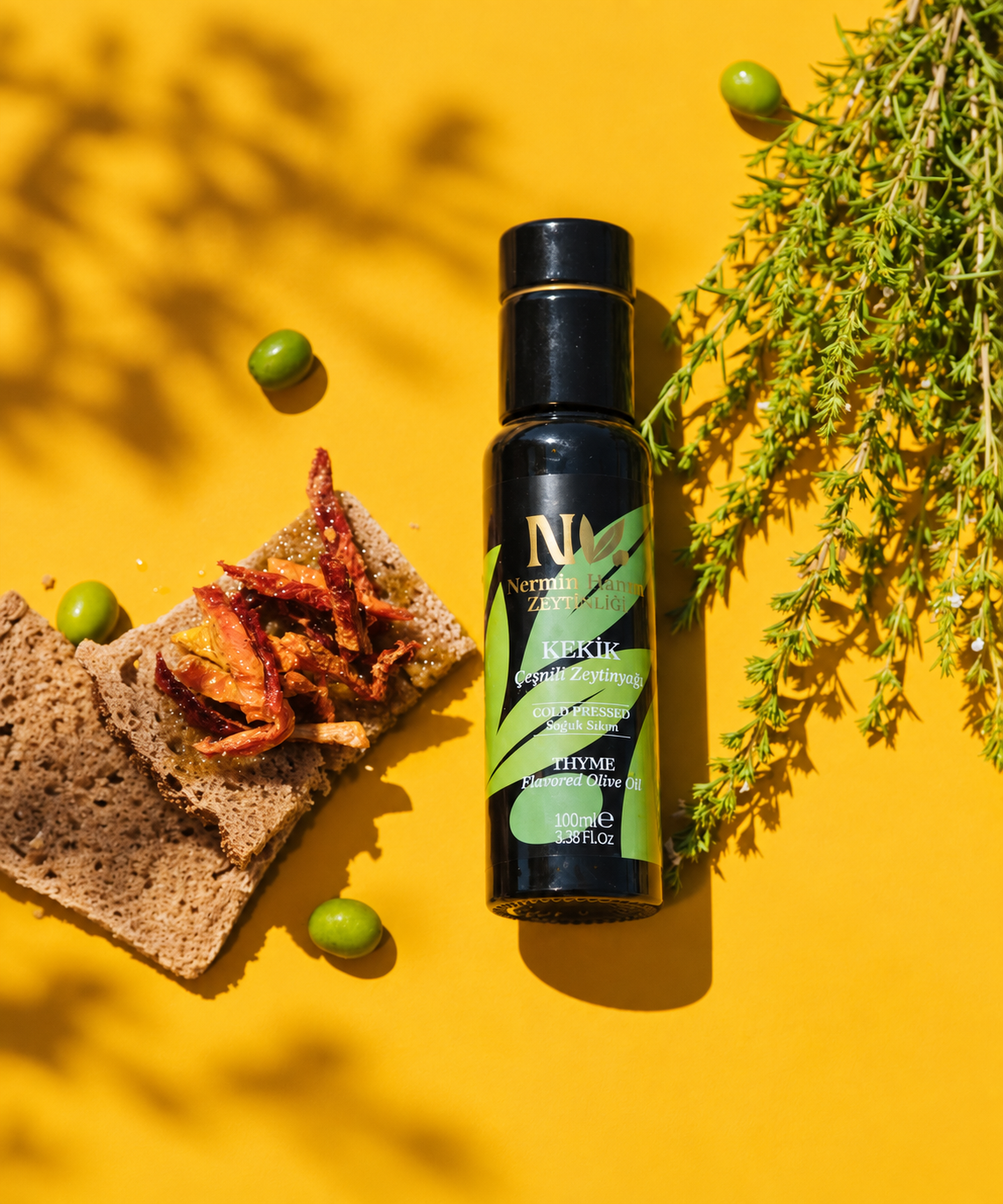 Nermin thyme flavored olive oil beside bread, olives and thyme