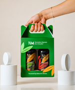 A hand carrying the green Taste of IDA Mountain olive oil gift pack